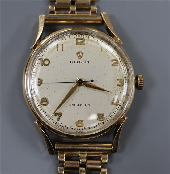 A gentlemans 9ct gold Rolex precision wristwatch, with gilt Arabic numerals, gold handles and blued steel centre